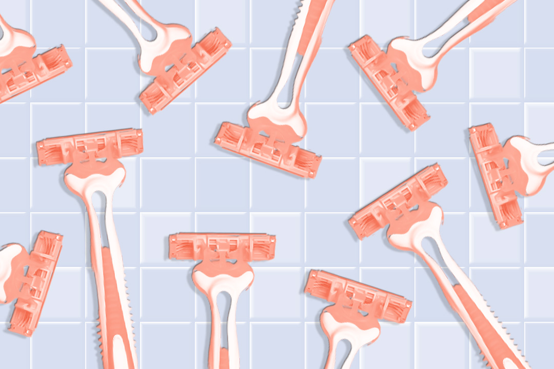 assortment of razors on a bathroom tile background